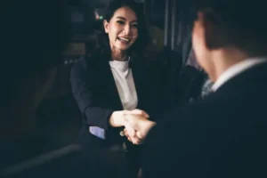 Business woman shaking hands with another business professional