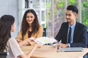 Woman sitting for an interview with a man and woman